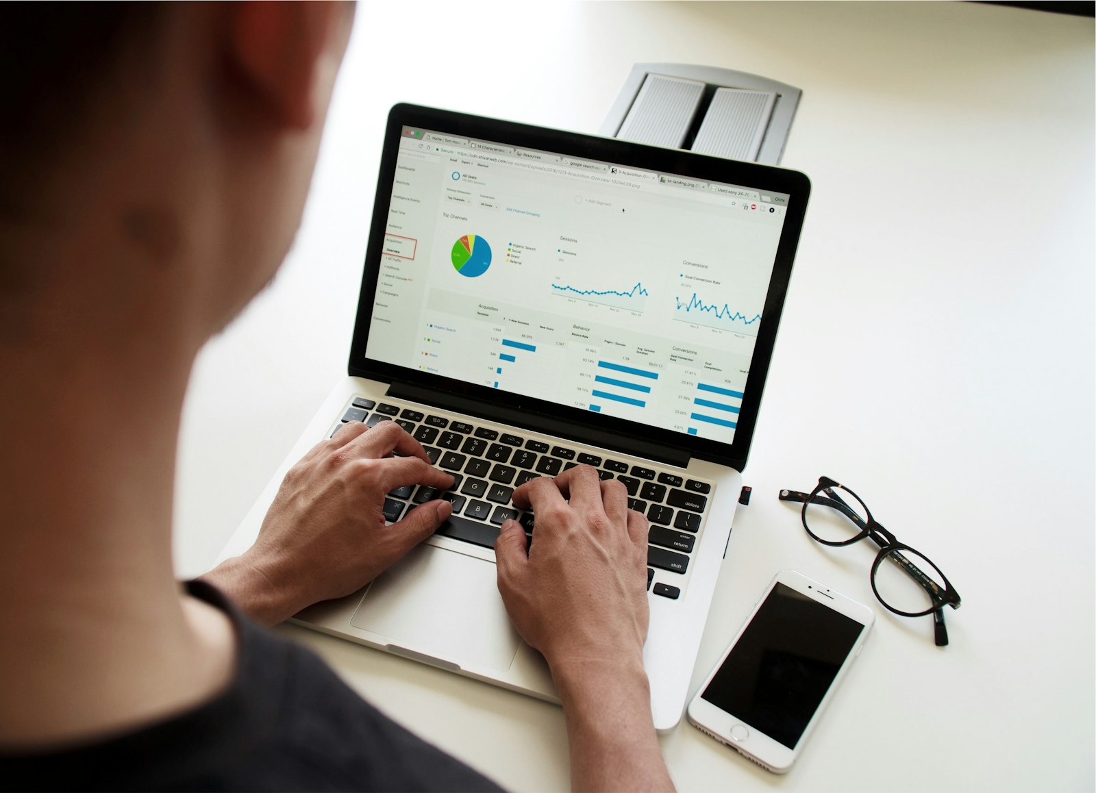 Two colleagues reviewing an analytics dashboard on a laptop